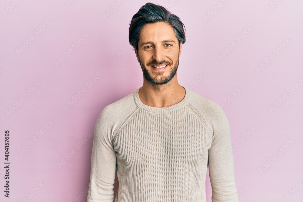 Young hispanic man wearing casual winter sweater with a happy and cool smile on face. lucky person. Young hispanic man wearing casual winter sweater with a happy and cool smile on face. lucky person.
