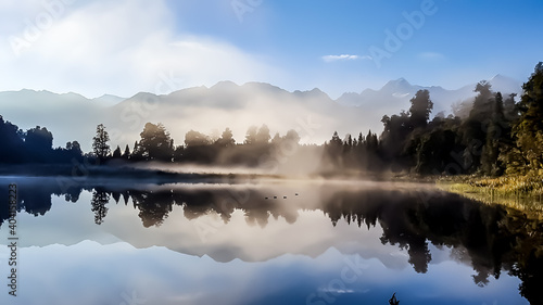 Foggy morning at Lake Matheson, New Zealand south island. The lake reflects the mountains of the southern alps, and the peaks of Mount Cook and Mount Tasman. It is a quiet and peaceful place in NZ.
