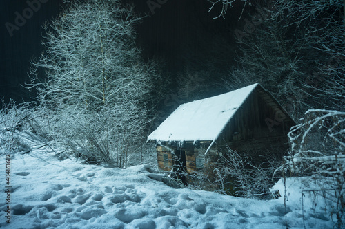 Old wooden hut in the winter forest