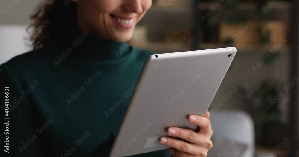 Close up happy young woman holds in hands tablet device, enjoy e-commerce purchase on retail web services, choose goods, buy fashion clothes online. Fast internet, modern tech, remote shopping concept Close up happy young woman holds in hands tablet device, enjoy e-commerce purchase on retail web services, choose goods, buy fashion clothes online. Fast internet, modern tech, remote shopping concept