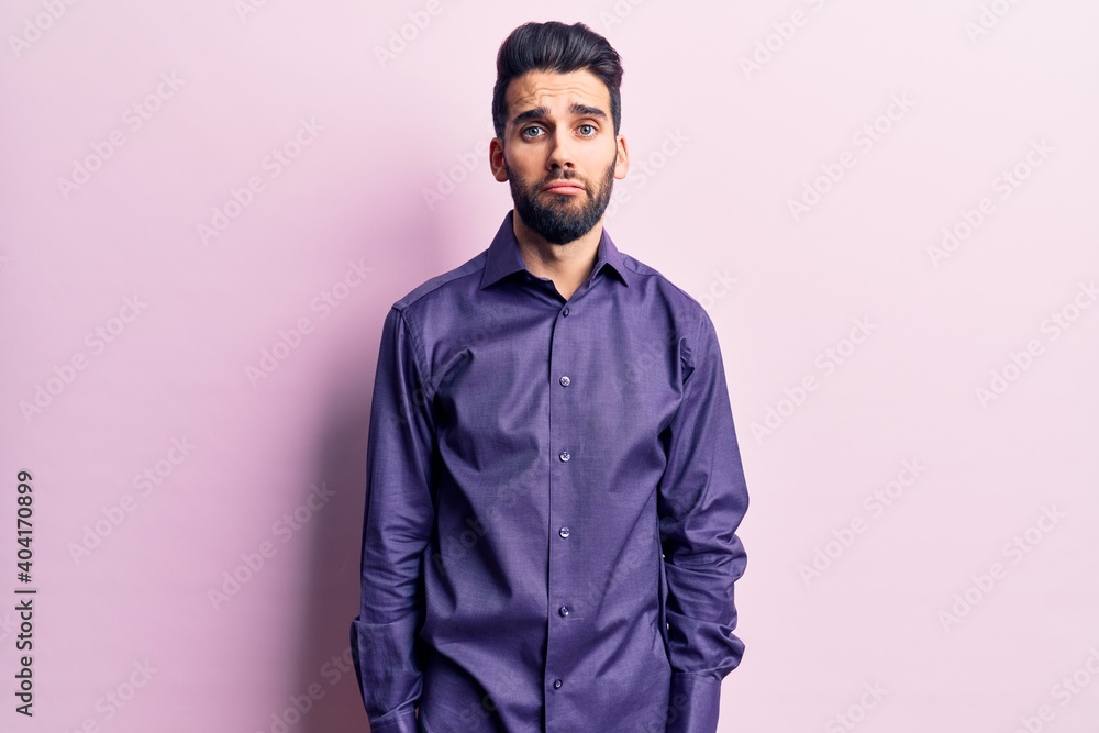 Obraz premium Young handsome man with beard wearing casual shirt depressed and worry for distress, crying angry and afraid. sad expression.
