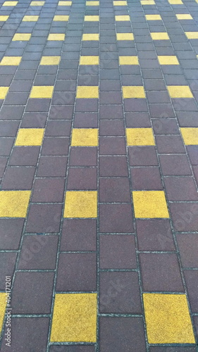 Sidewalk tiles with a pattern, covering the pedestrian area