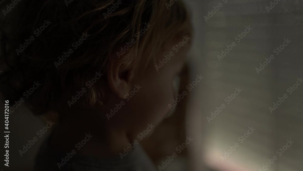 Cute little baby toddler opening automatic blinds in the morning, starting the day Cute little baby toddler opening automatic blinds in the morning, starting the day