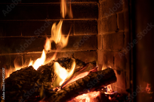 tongues of fire in a heated stone fireplace, horizontal