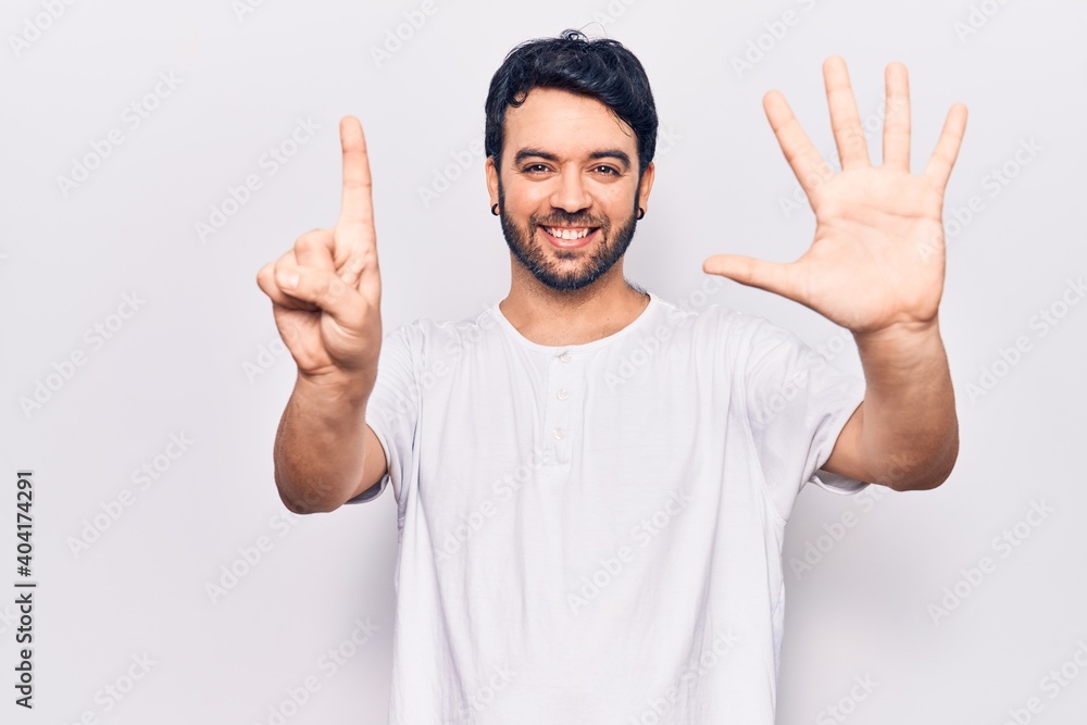 Young hispanic man wearing casual clothes showing and pointing up with fingers number six while smiling confident and happy. Young hispanic man wearing casual clothes showing and pointing up with fingers number six while smiling confident and happy.