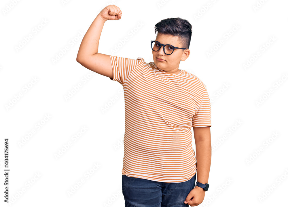 Fototapeta premium Little boy kid wearing casual clothes and glasses strong person showing arm muscle, confident and proud of power