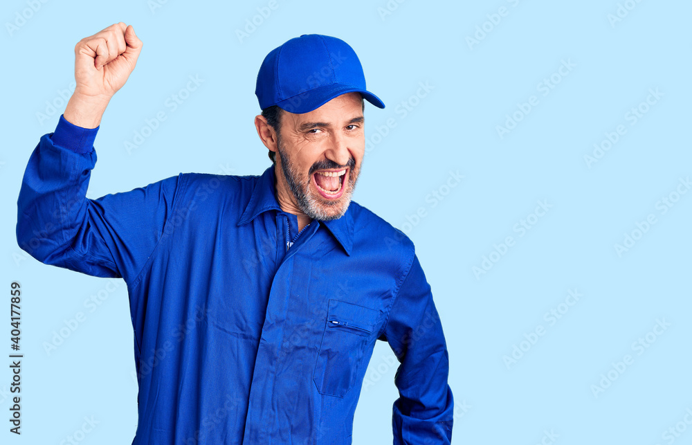 Middle age handsome man wearing mechanic uniform dancing happy and cheerful, smiling moving casual and confident listening to music Middle age handsome man wearing mechanic uniform dancing happy and cheerful, smiling moving casual and confident listening to music