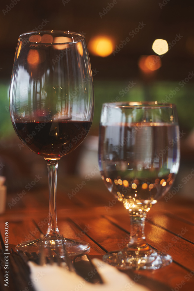 Close up wine glass with wine on the table with dinner set in the restaurant Close up wine glass with wine on the table with dinner set in the restaurant
