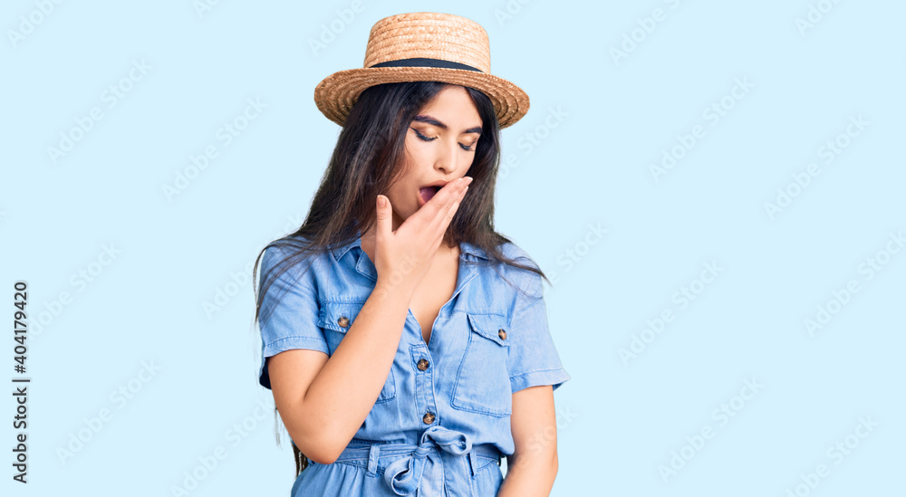 Brunette teenager girl wearing summer hat bored yawning tired covering mouth with hand. restless and sleepiness. Brunette teenager girl wearing summer hat bored yawning tired covering mouth with hand. restless and sleepiness.