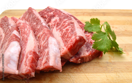 raw beef ribs on wooden board