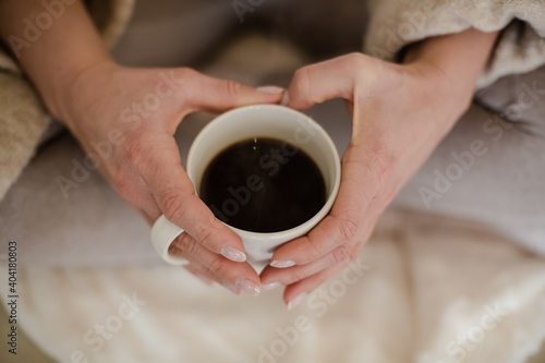 holding cup with hot coffee