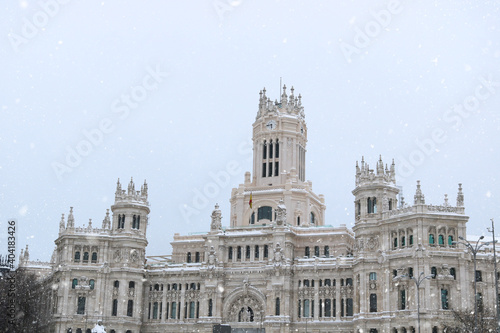 Madrid center with the monument of the city hall in the background while snowing - winter postcard from Spain