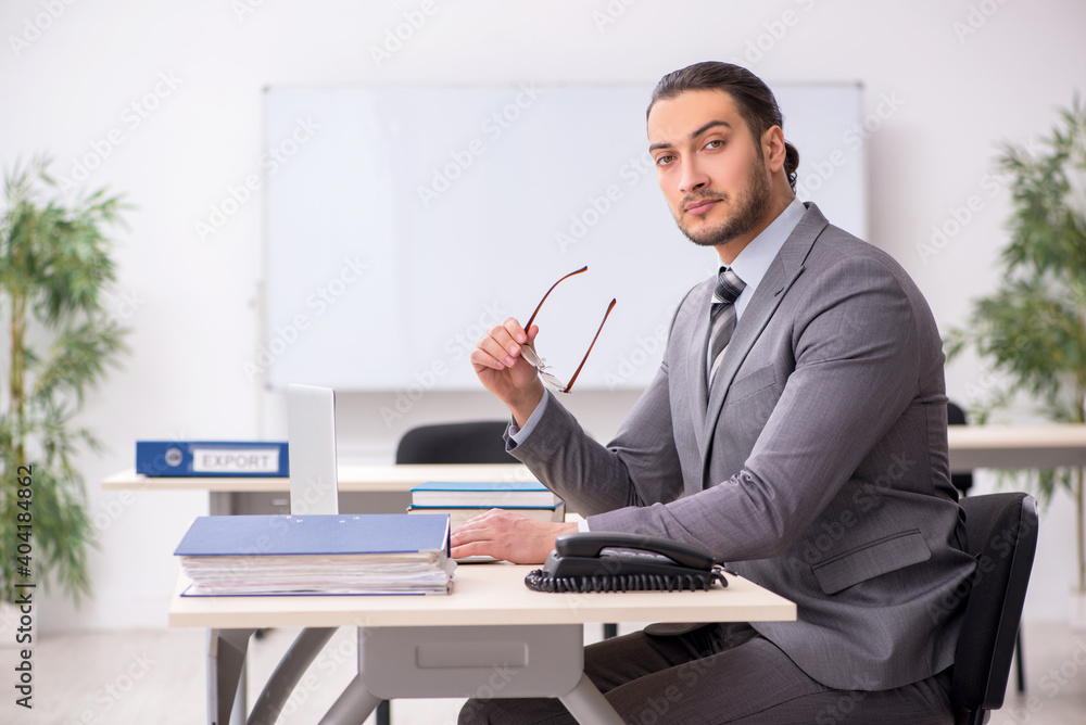 Young male employee working in the office Young male employee working in the office