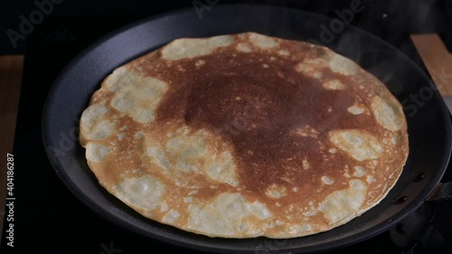 Wallpaper Mural Russian pancake is fried in a pan. The process of making thin pancakes for carnival. High quality 4k footage Torontodigital.ca