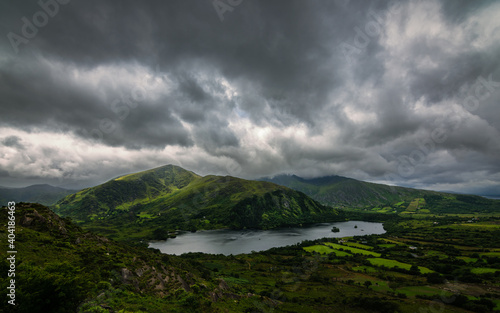 Amazing landscape of Ireland, stormy sky, green mountains and deep lakes