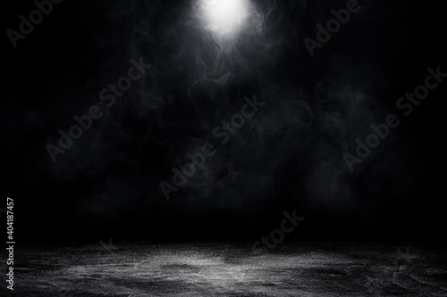 Empty space of Studio dark room concrete floor grunge texture background with spot lighting and fog or mist in black background.