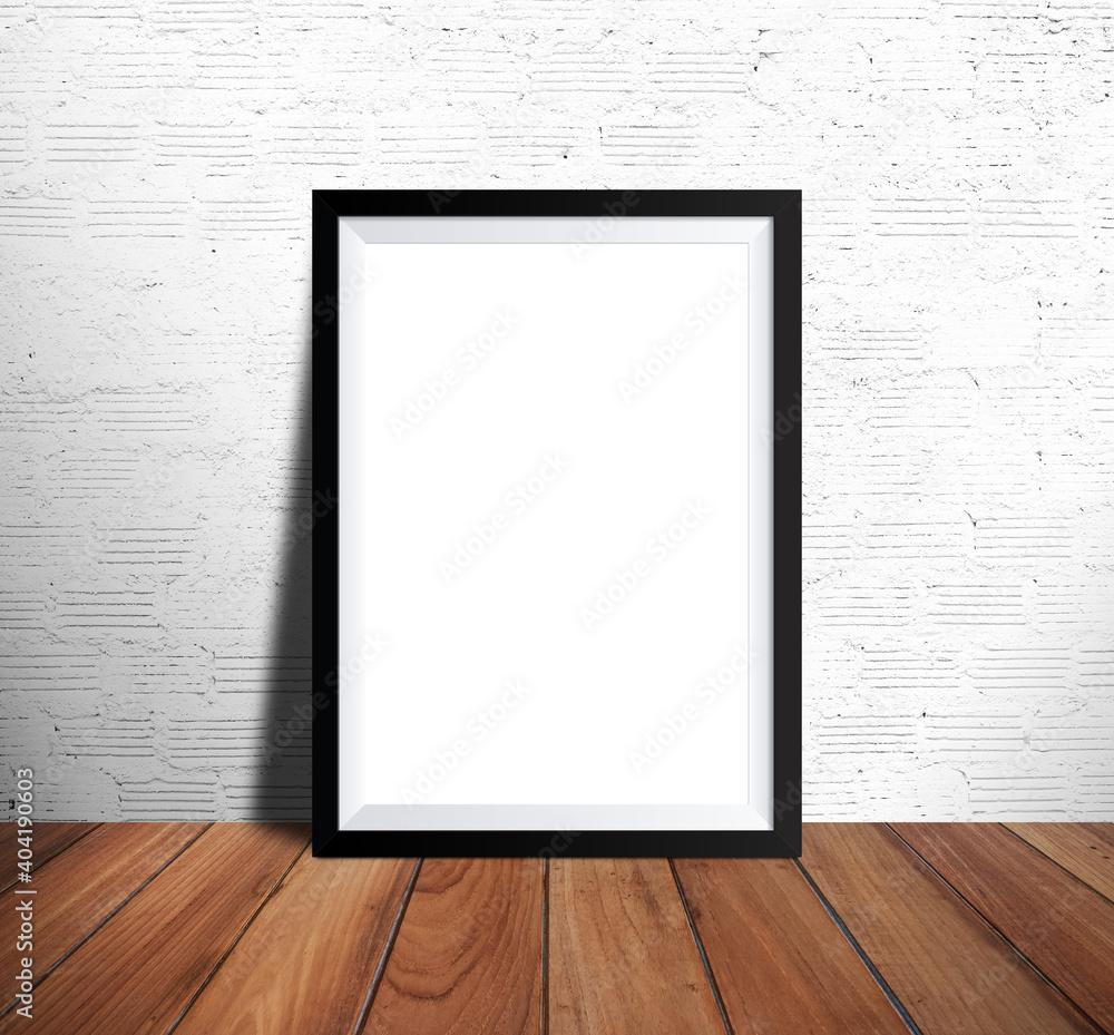 White picture frame in white brick wall and wooden floor room White picture frame in white brick wall and wooden floor room