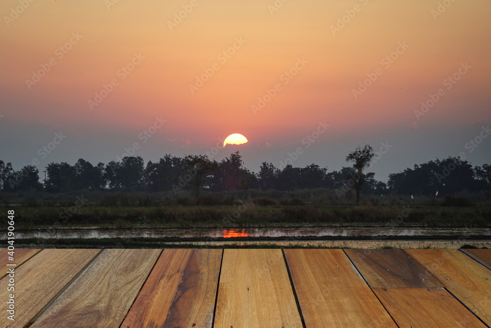 Empty wooden table on sunset nature background. Mock up for your product display or montage