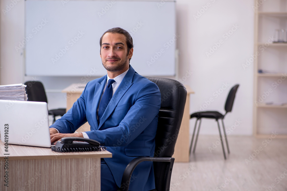 Young male employee and too much work in the office Young male employee and too much work in the office