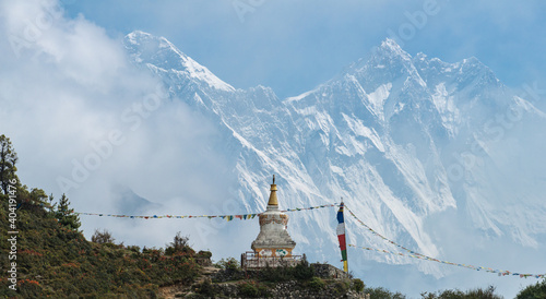 Tenzing Norgay memorial stupa with dramatic view of Mt.Everest and Mt.Lhotse behind the mist (Focus at stupa). photo