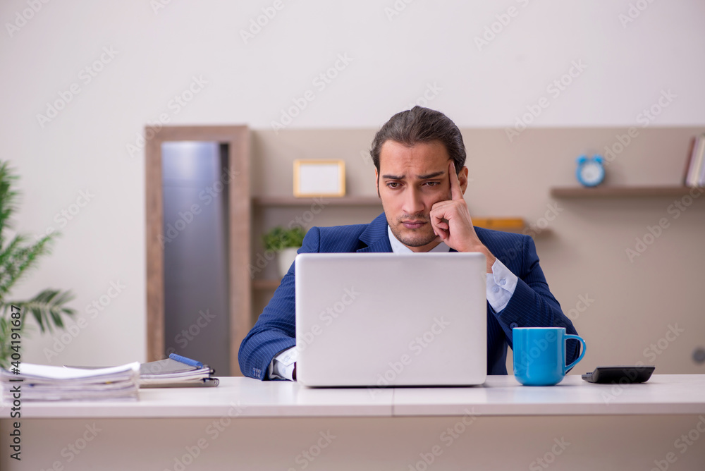 Young male employee working from home in pandemic concept Young male employee working from home in pandemic concept