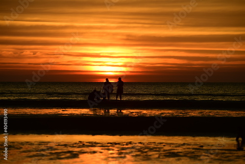 Beautiful golden yellow sky and sun The view of the beach, the beach and the sun loungers are rising. Beautiful golden yellow sky and sun	