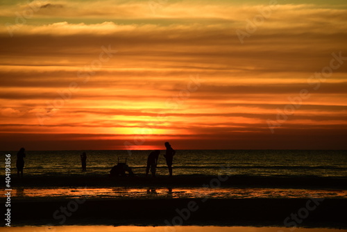 Beautiful golden yellow sky and sun The view of the beach  the beach and the sun loungers are rising. Beautiful golden yellow sky and sun 