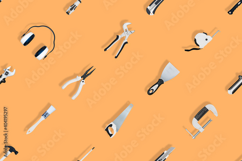 Tools seamless pattern. Various construction tools on an orange background.