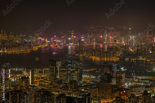 Victoria Harbour with Hong Kong Island visible in the distance as seen from the top of Kowloon peak in the night. 