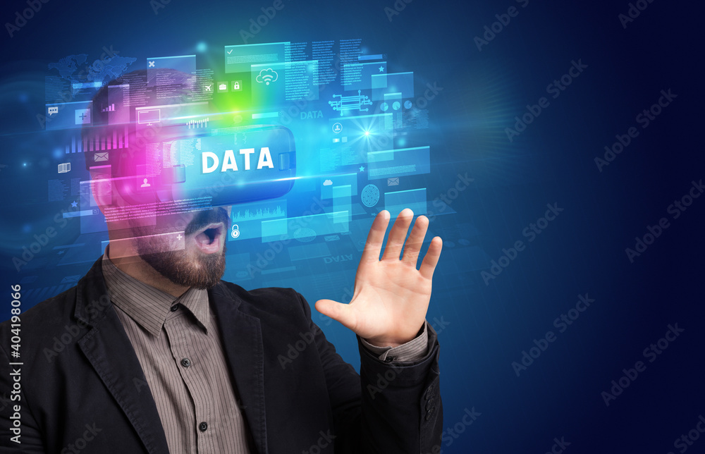 Businessman looking through Virtual Reality glasses with DATA inscription, innovative security concept Businessman looking through Virtual Reality glasses with DATA inscription, innovative security concept