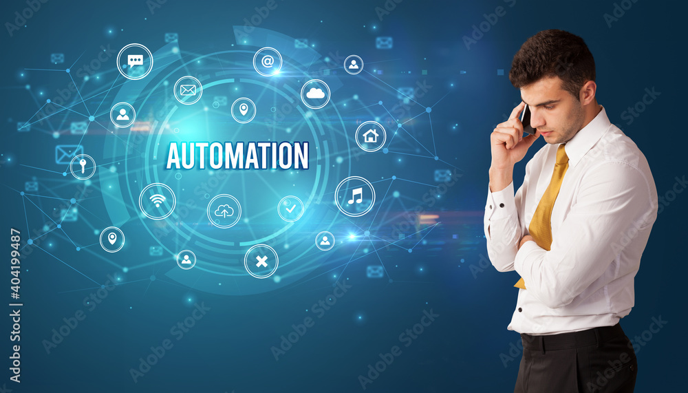 Businessman thinking in front of technology related icons and AUTOMATION inscription, modern technology concept Businessman thinking in front of technology related icons and AUTOMATION inscription, modern technology concept