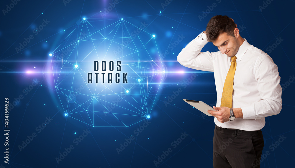 Businessman thinking about security solutions with DDOS ATTACK inscription Businessman thinking about security solutions with DDOS ATTACK inscription