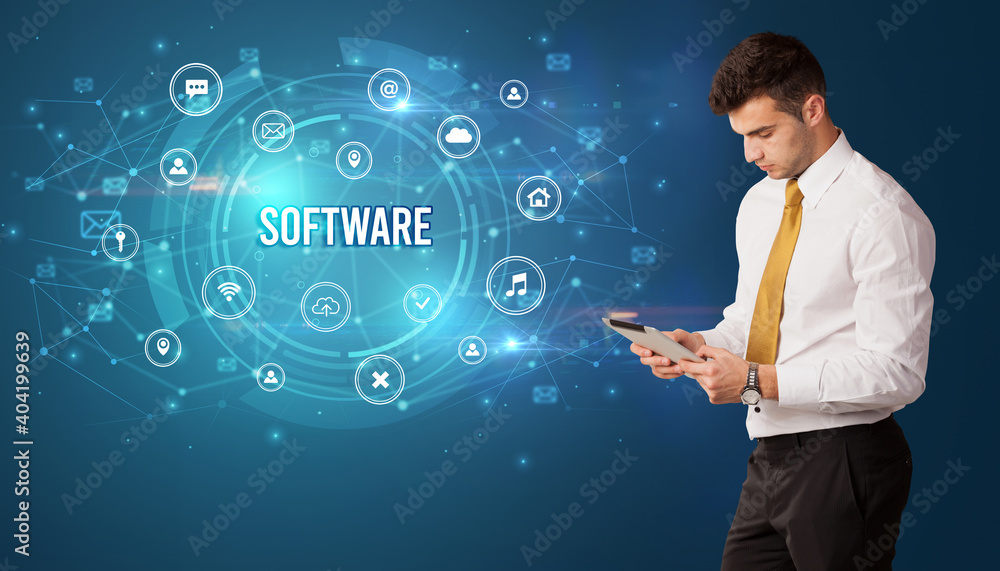 Businessman thinking in front of technology related icons and SOFTWARE inscription, modern technology concept Businessman thinking in front of technology related icons and SOFTWARE inscription, modern technology concept