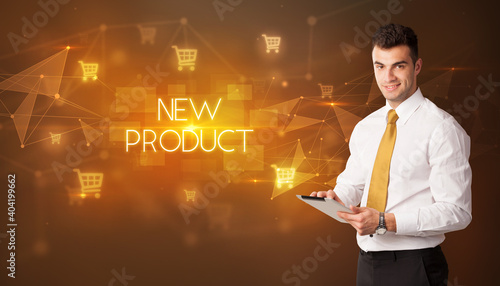 Businessman with shopping cart icons and NEW PRODUCT inscription, online shopping concept