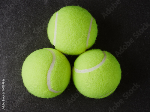 Sport and healthy lifestyle. Tennis. Yellow ball for tennis and a racket on table. Sports background with tennis concept. © Mikhail