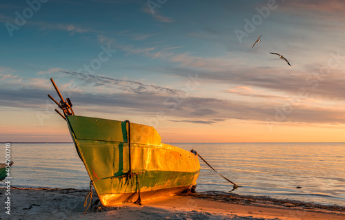 Anchored on sandy beach fishing boats near a small village of fishermen; here...