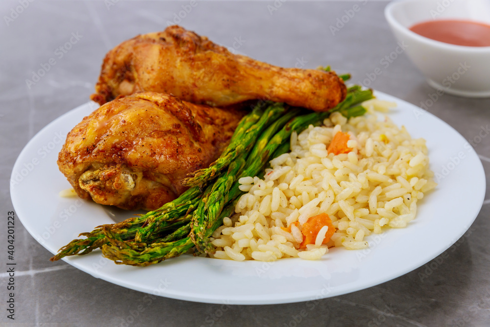 Grilled chicken drumsticks with rice and buffalo sauce. Grilled chicken drumsticks with rice and buffalo sauce.
