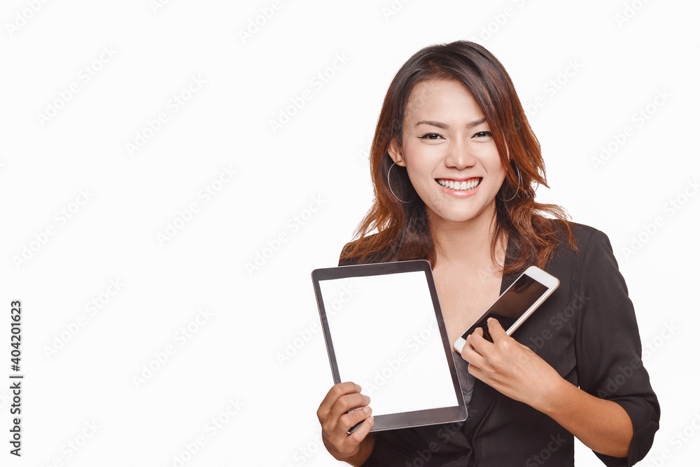 Smiling asian woman Is holding a cell phone and touchpad in a Smiling asian woman Is holding a cell phone and touchpad in a
