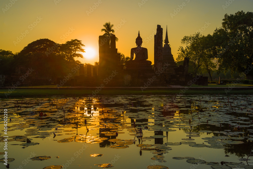 Ruins of the ancient Buddhist temple of Wat Chana Songkram at sunset. Historical Park of Sukhothai city, Thailand