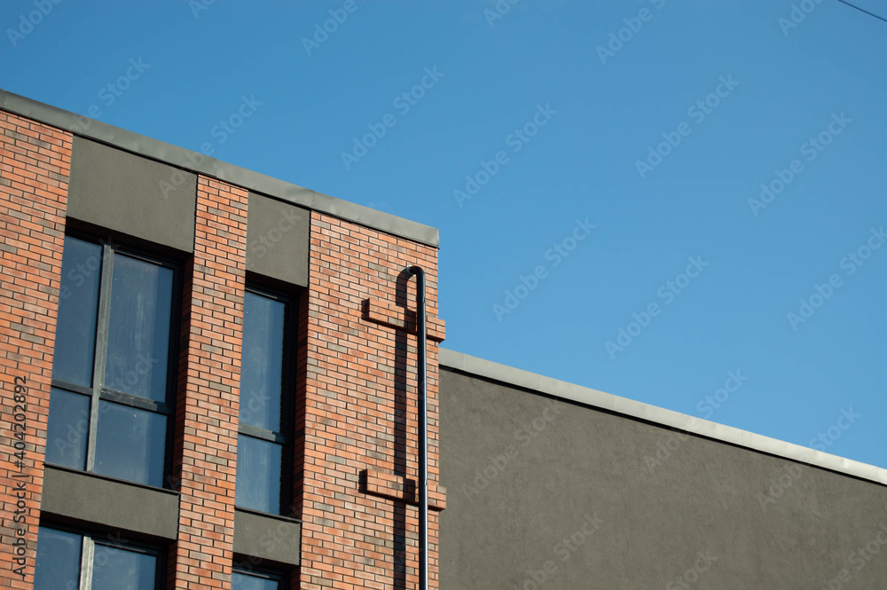 corner of a modern brick cinema building in front of the sun corner of a modern brick cinema building in front of the sun