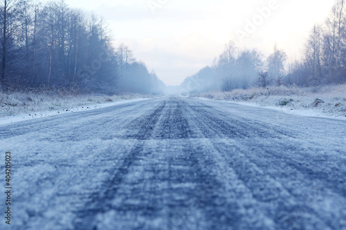 road in ice and snow at wintertime/ danger driving/ winter road at forest
