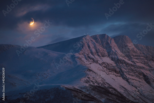 Moon rise over arctic mountains  Tromso  northern Norway