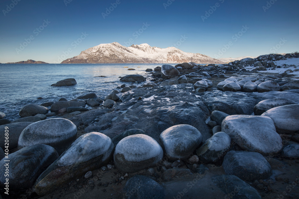Arctic islands - Vengsoya island viewed from the shores of Kvaloya island, northern Norway Arctic islands - Vengsoya island viewed from the shores of Kvaloya island, northern Norway