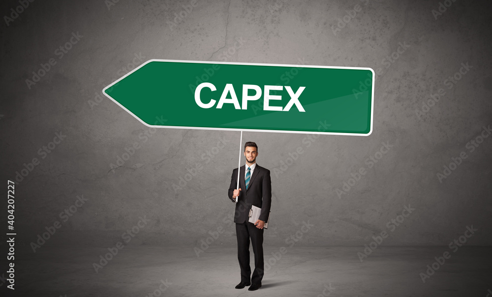 Obraz premium Young business person in casual holding road sign with CAPEX inscription, new business direction concept