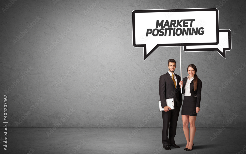 Young business person in casual holding road sign with MARKET POSITIONING inscription, new business idea concept Young business person in casual holding road sign with MARKET POSITIONING inscription, new business idea concept