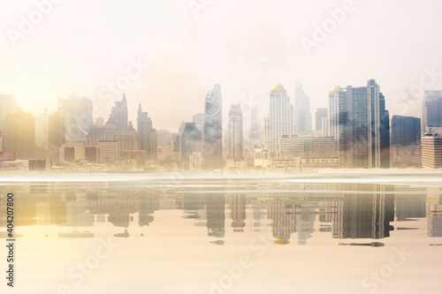 Beautiful landscape abstract city background and The light of sun reflection building on water.
