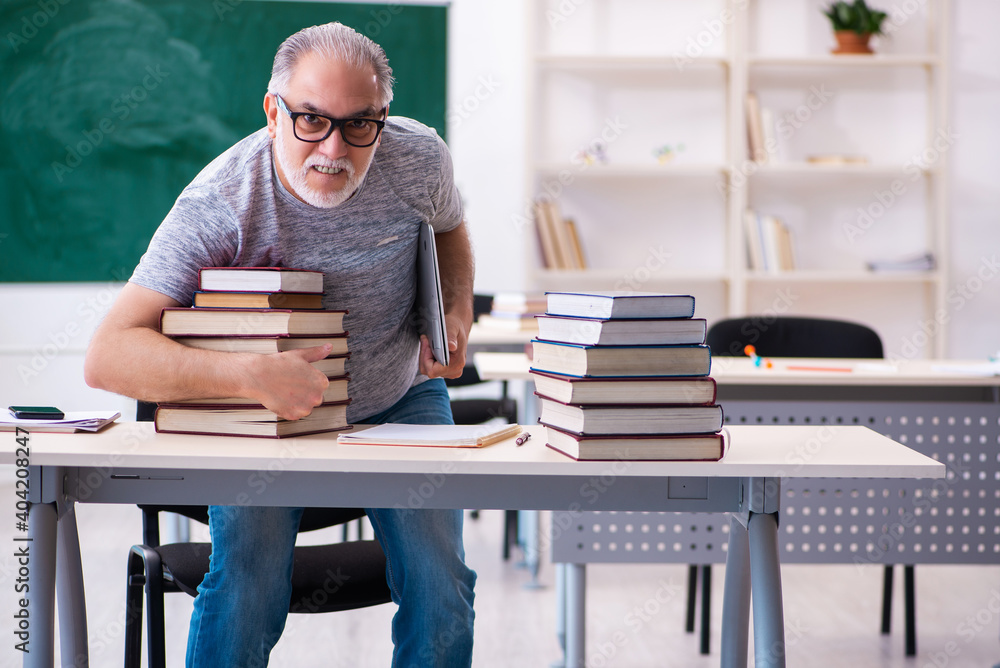 Old male student preparing for exams in the classroom Old male student preparing for exams in the classroom