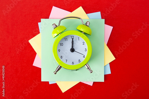 Alarm clock on red background.