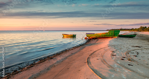 Anchored on sandy beach fishing boats near a small village of fishermen; here...