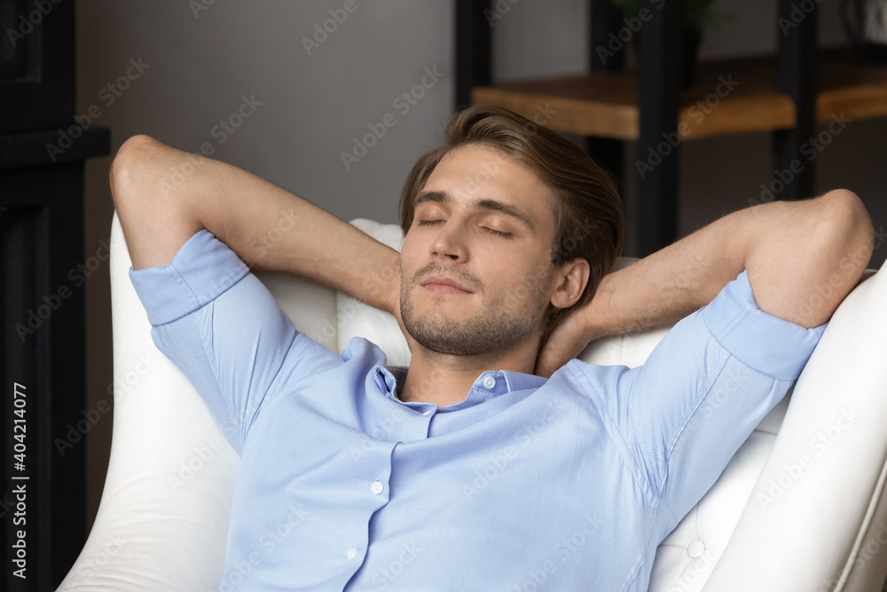 Close up of tired millennial Caucasian man sit rest in chair at home sleeping or taking nap. Calm young male relax in armchair daydream, relieve bad negative emotions. Stress free, peace concept. Close up of tired millennial Caucasian man sit rest in chair at home sleeping or taking nap. Calm young male relax in armchair daydream, relieve bad negative emotions. Stress free, peace concept.